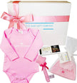 Baby gift set with pink 'Little Princess' outfit, hat, and other items in front of 'The Baby Gift Company' box.