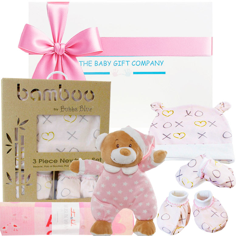 Baby gift set with teddy bear, clothes, and accessories from The Baby Gift Company.