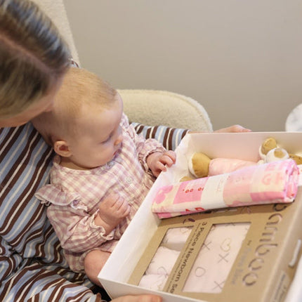 Mum with their baby looking at Pretty in Pink Organic Baby Girl Gift box