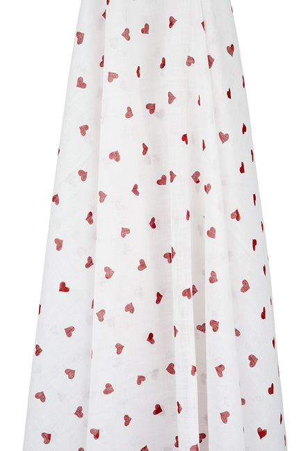 White muslin wrap with red heart patterns on a white background