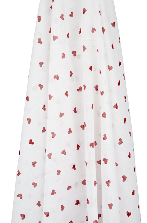 White muslin wrap with red heart patterns on a white background