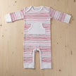 Red stripe scribble baby romper on wooden table