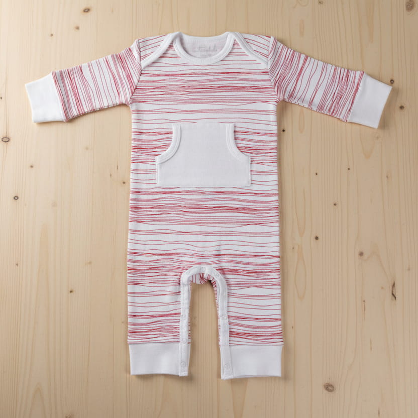 Red stripe scribble baby romper on wooden table