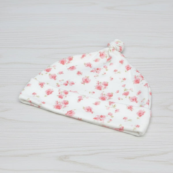 Flower baby hat on table 