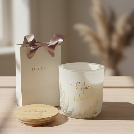 Relax and Unwind Candle and gift bag on a table surface