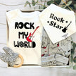 Baby clothing set with 'Rock My World' and 'Rock Star' text, baby bib, and teething ring in a gift box.