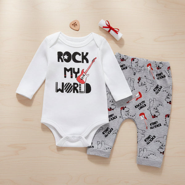 Baby outfit with white long-sleeve onesie and gray pants featuring 'Rock My World' text and guitar graphics on a table background.