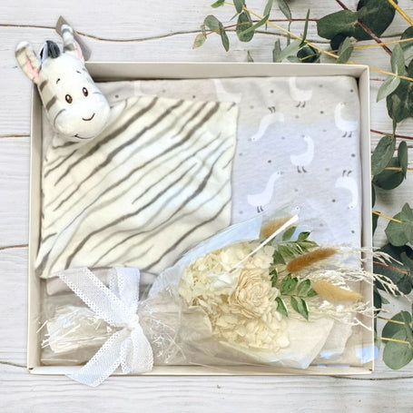 baby gift box with zebra toy, flowers and blanket