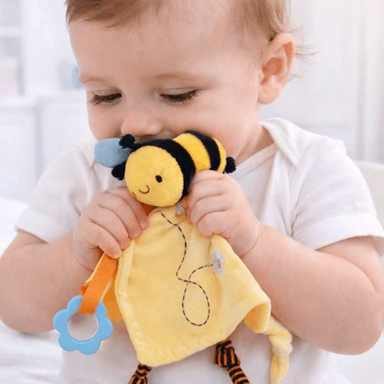 Yellow Hunny Bee Comforter in baby's hands