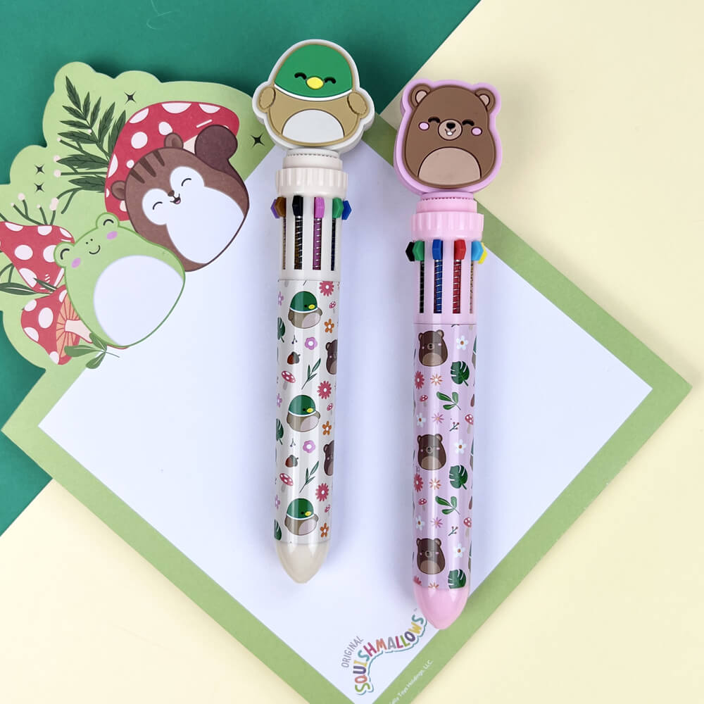 Two colorful pens with animal-themed designs on a green and beige background.