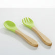 Green-handled spoon and fork with wooden handles on a white background