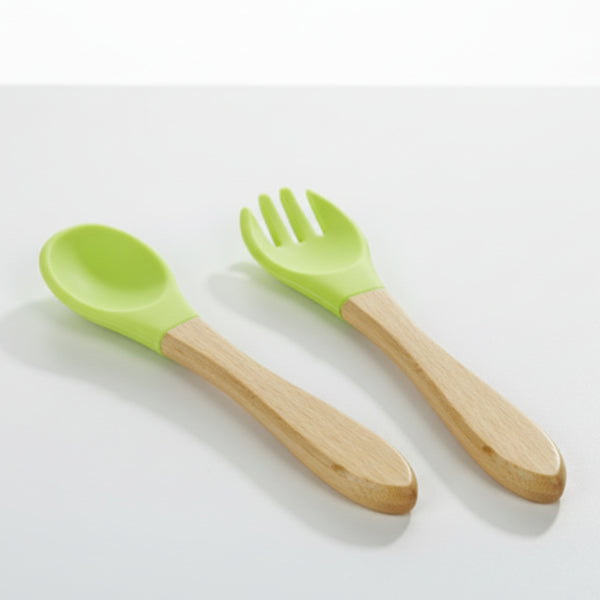 Green-handled spoon and fork with wooden handles on a white background