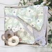 Baby koala clothing with toy in a gift box on a wooden surface