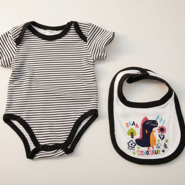 Black and white striped baby bodysuit and colorful bib with dinosaur design on a white background