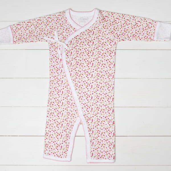 Baby onesie with red floral pattern on a white background