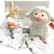 Baby gift set with plush lamb toy, Johnson's baby wipes, and Little Linen muslin wrap.