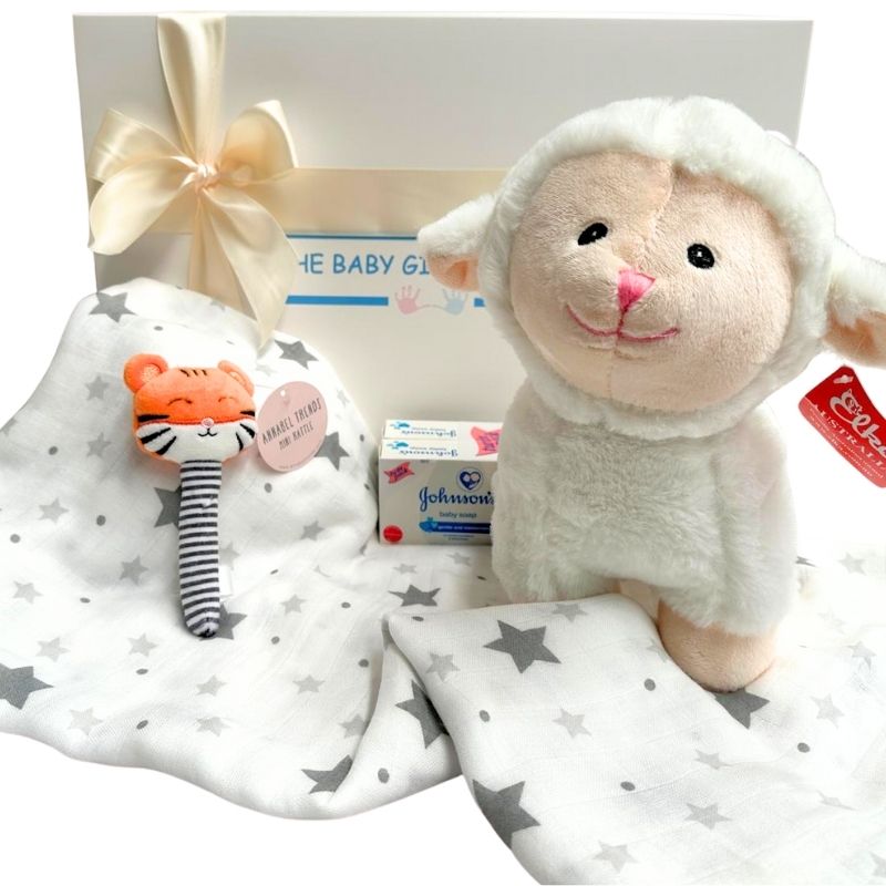 Baby gift set with plush lamb toy, Johnson's baby wipes, and Little Linen muslin wrap.