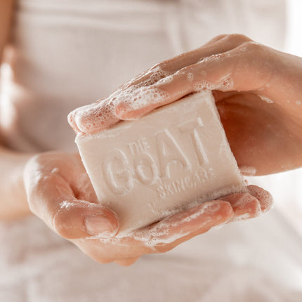 Person holding a bar of soap with 'The Soap' branding.