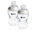 Two Tommee Tippee baby bottles on a white background