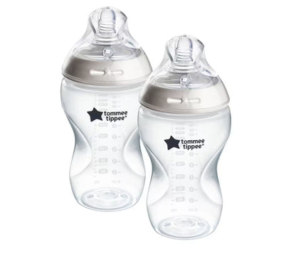 Two Tommee Tippee baby bottles on a white background