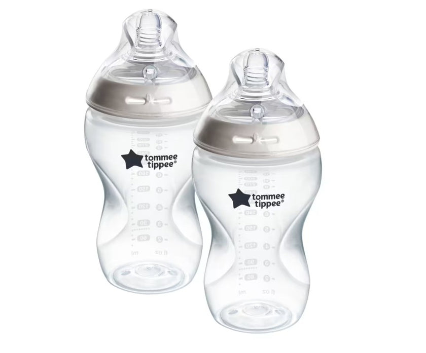 Two Tommee Tippee baby bottles on a white background