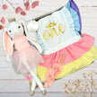Plush bunny toy and One birthday baby girl romper in a gift box