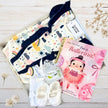 Gift box with frilly baby girl clothes , white shoes and ballerina book