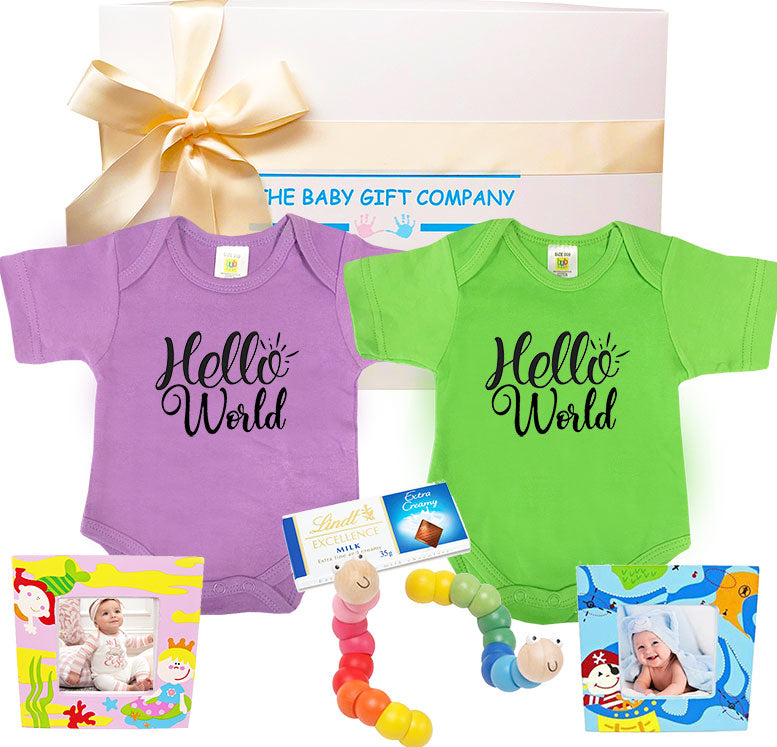 Baby gift set with 'Hello World' onesies, toys, and photo cards from The Baby Gift Company.