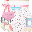 Baby gift set with bib, romper, socks, and other items from The Baby Gift Company.