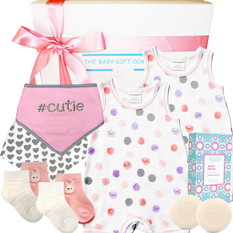 Baby gift set with bib, romper, socks, and other items from The Baby Gift Company.