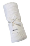 White textured baby blanket with a visible brand label on a white background