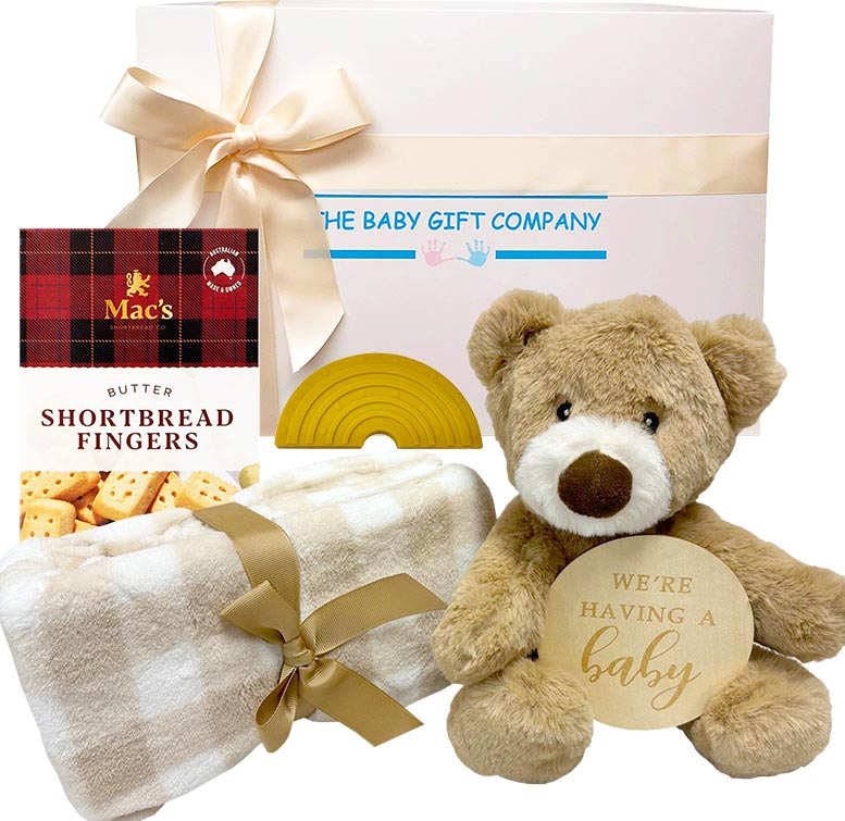 Baby gift set with teddy bear, blanket, and shortbread fingers from The Baby Gift Company.