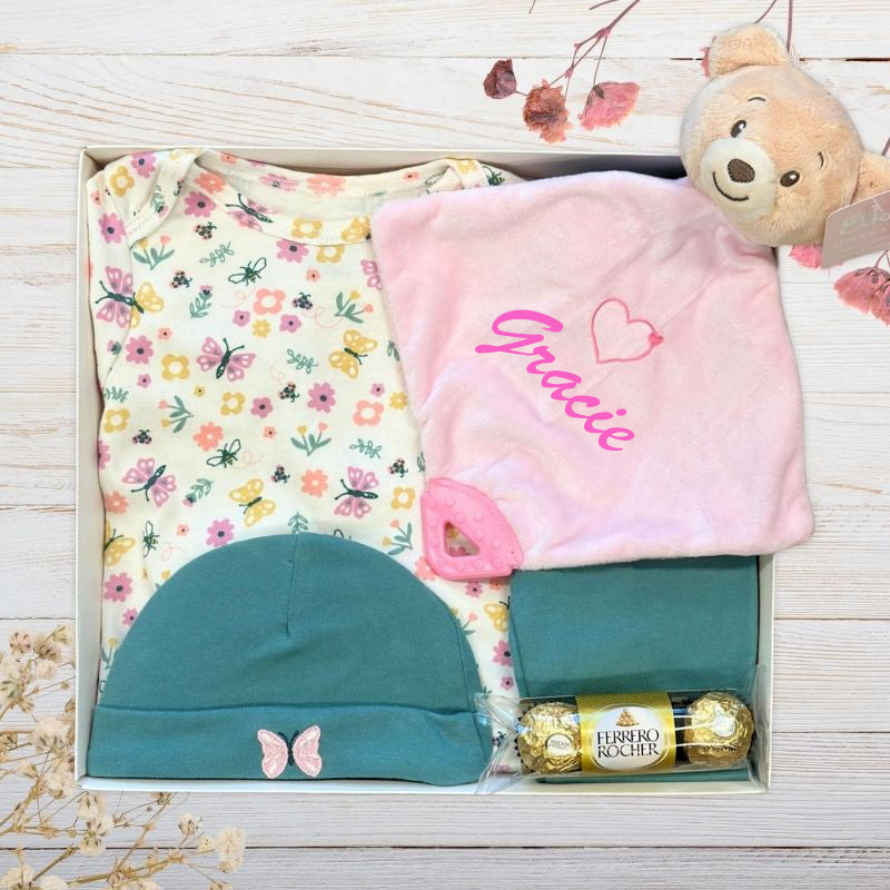 gift set with baby clothes and pink bear
