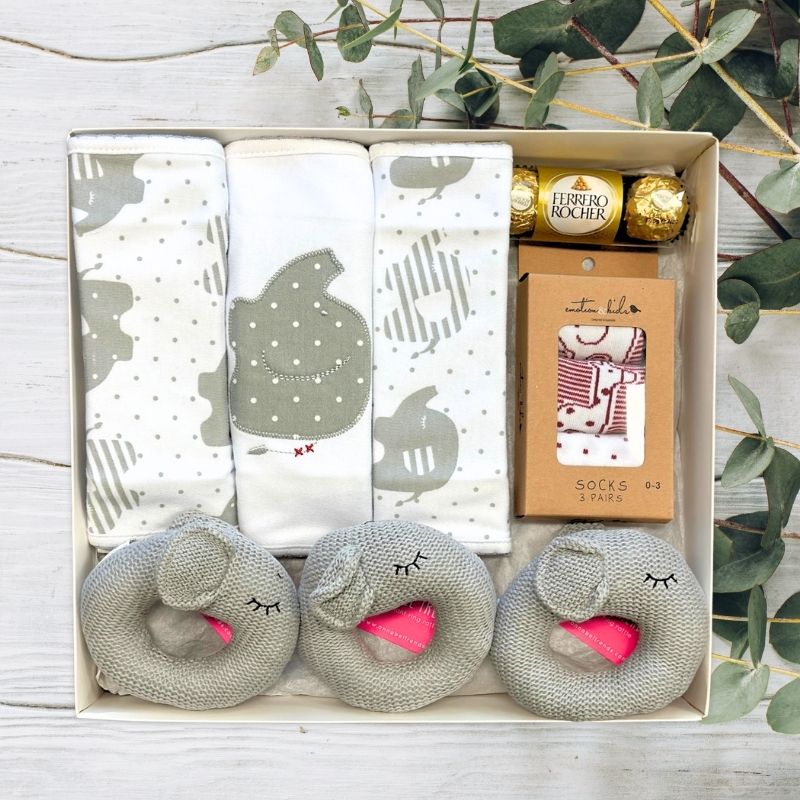 baby gift box with grey elephant rattles and bibs