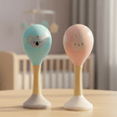 Two baby rattles with animal faces in a baby nursery