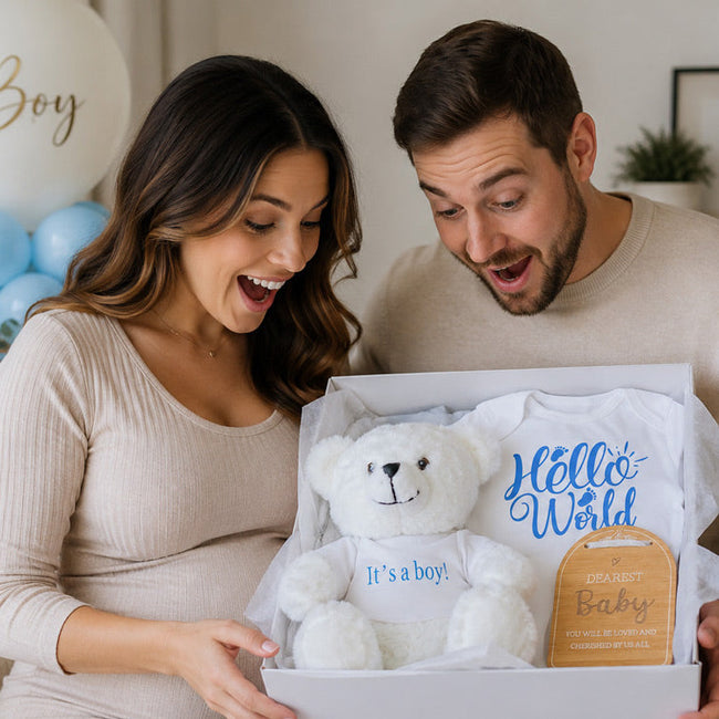 Baby Boy Gender Reveal Gift Hamper with white 'It's a Boy' teddy bear and blue Hello World onesie from The Baby Gift Company