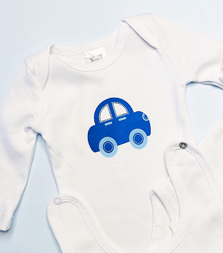 White baby onesie with blue car design and matching blue plush toy on a light gray background