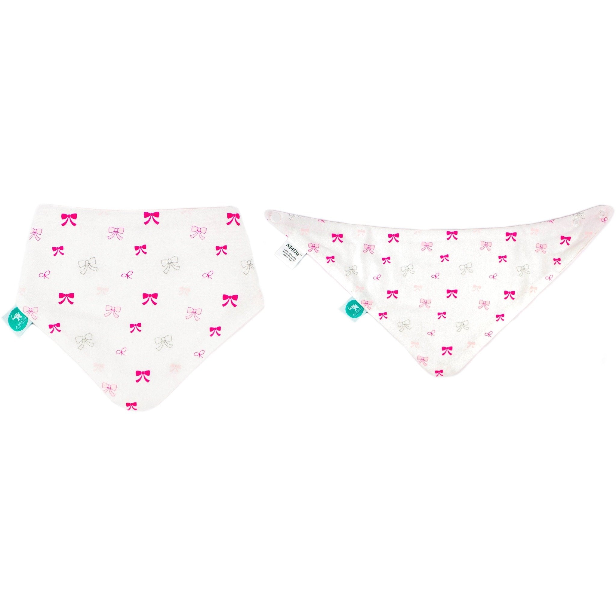 Two baby bibs with bow pattern on a white background