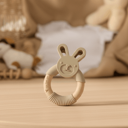a bunny-shaped teether on a brown textured surface