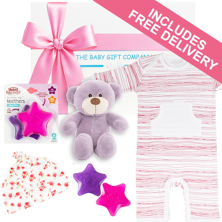 Baby gift set with purple teddy bear, star-shaped teether, and baby clothes on a white background.