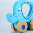 Blue elephant-shaped toy with wooden wheels on a light gray background