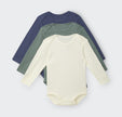 Three ribbed bonds baby bodysuits, one navy and one cream and one green with long sleeves, on a background.
