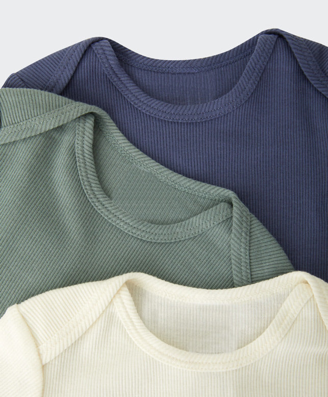 Close up of baby clothing on a white background