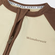 Bonds ivory and brown baby Zip Wondersuit on a white background