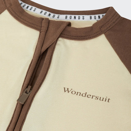 Bonds ivory and brown baby Zip Wondersuit on a white background