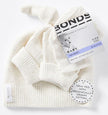 White baby hat with 'Bonds' label on a white background