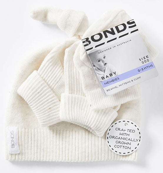 White baby hat with 'Bonds' label on a white background