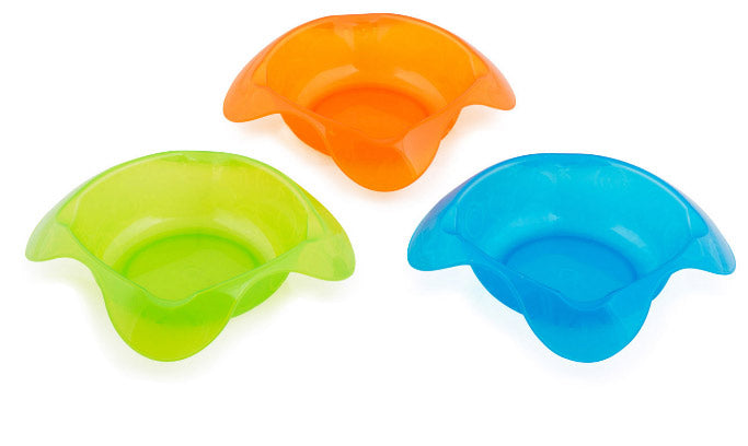 Three colorful plastic baby seats in orange, green, and blue on a white background
