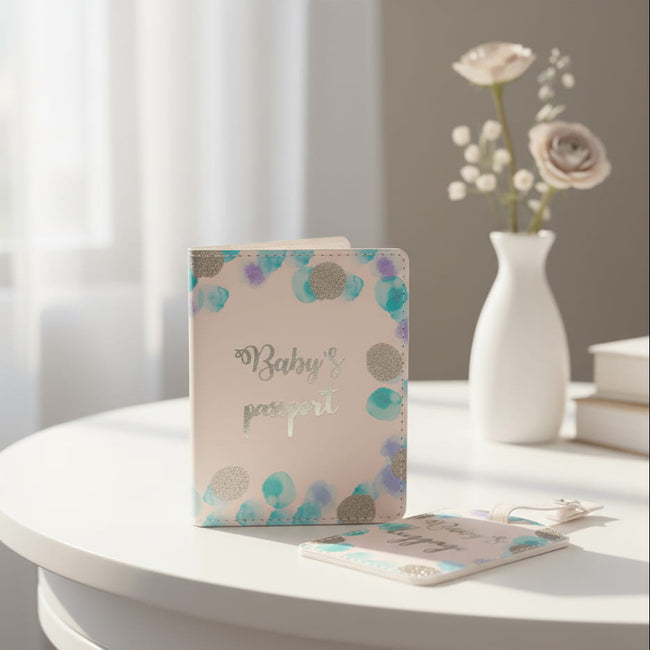 Baby-themed passport cover and luggage tag with colorful polka dot design on a table