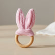 Pink knitted bunny ear teething ring on a white background
